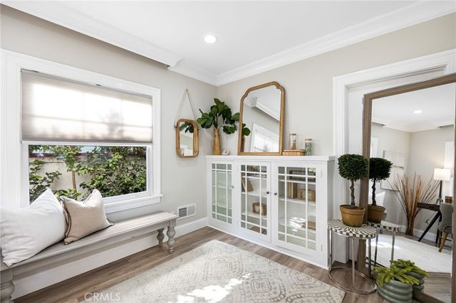 a living room with furniture a rug and a large window