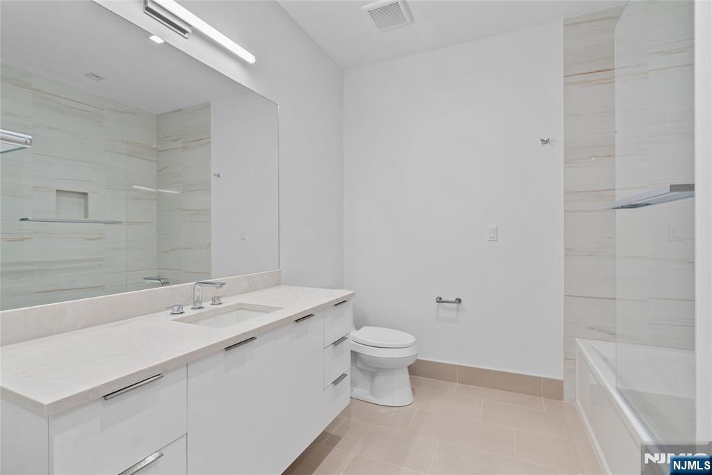 620 Bloomfield Avenue, Unit PHB Bloomfield, NJ 07003 - Photo 11 of 36 a bathroom with a sink a toilet and shower