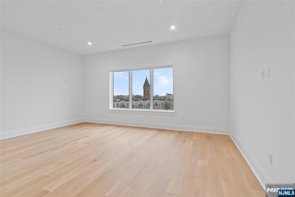 620 Bloomfield Avenue, Unit PHB Bloomfield, NJ 07003 - Photo 6 of 36 wooden floor in an empty room with a window