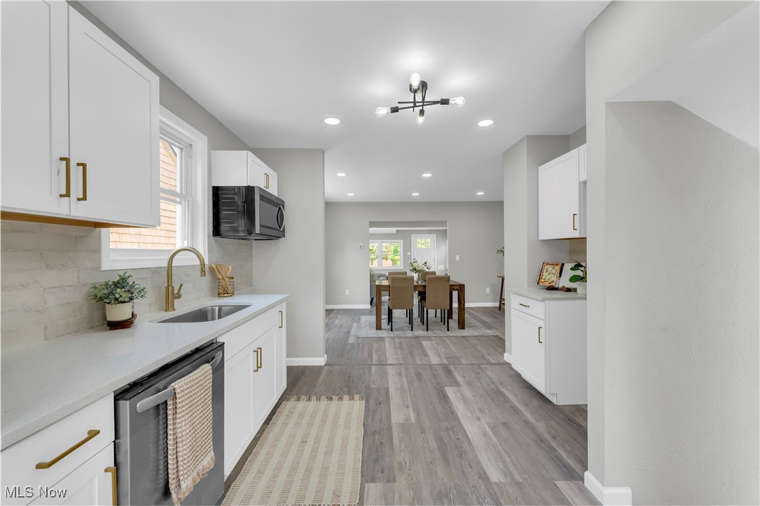 4124 Bayard Road Cleveland, OH 44121 - Photo 15 of 35 Kitchen featuring backsplash, white cabinets, stainless steel appliances, and recessed lighting