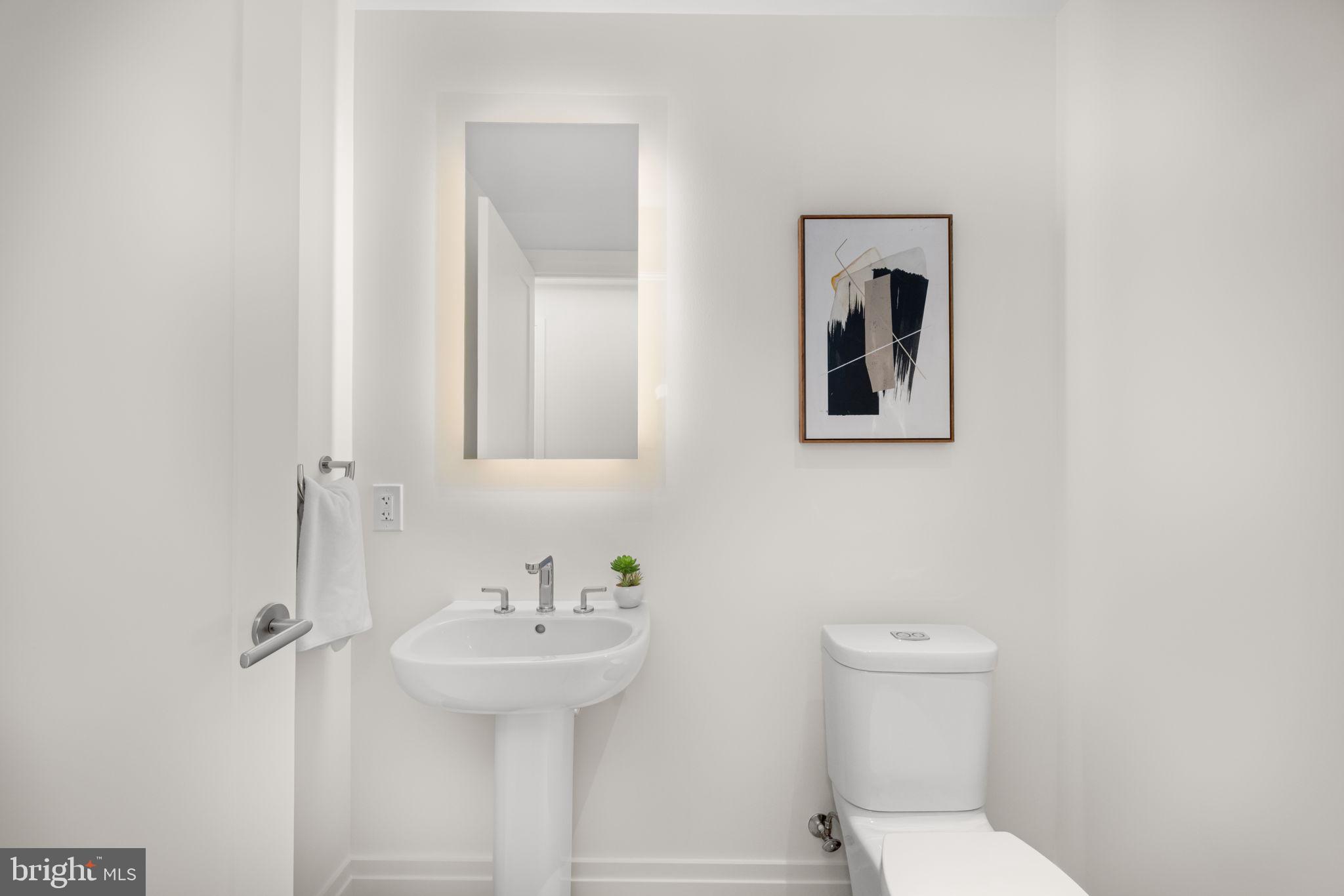 2501 M Street Northwest, Unit T04 Washington, DC 20037 - Photo 21 of 24 a bathroom with a toilet sink and mirror