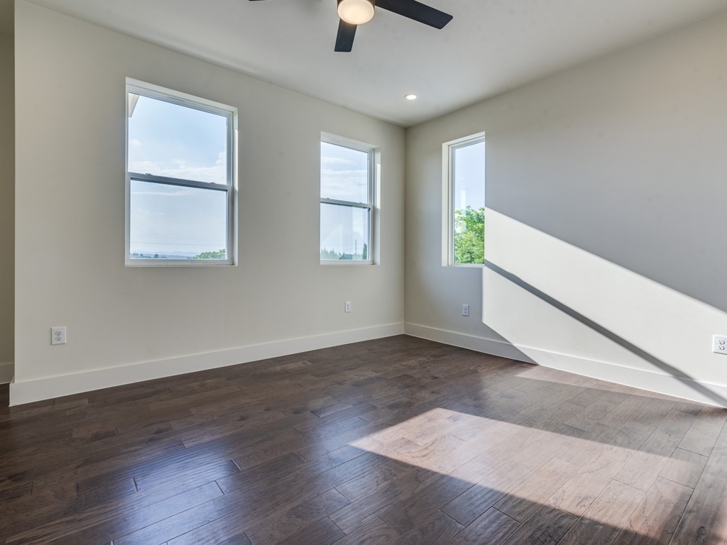 6412 Carson Ridge, Unit B Austin, TX 78741 - Photo 14 of 29 wooden floor in an empty room with a window