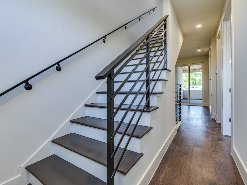 6412 Carson Ridge, Unit B Austin, TX 78741 - Photo 16 of 29 a view of entryway with wooden floor and stairs
