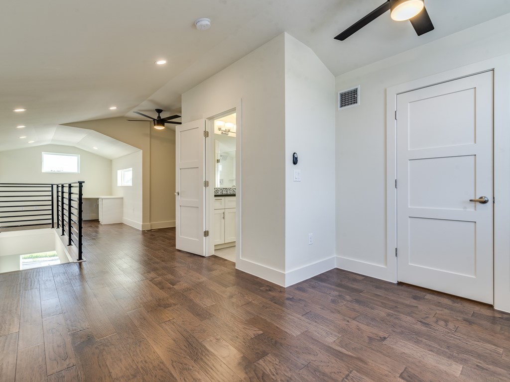 6412 Carson Ridge, Unit B Austin, TX 78741 - Photo 18 of 29 wooden floor in an empty room with a window