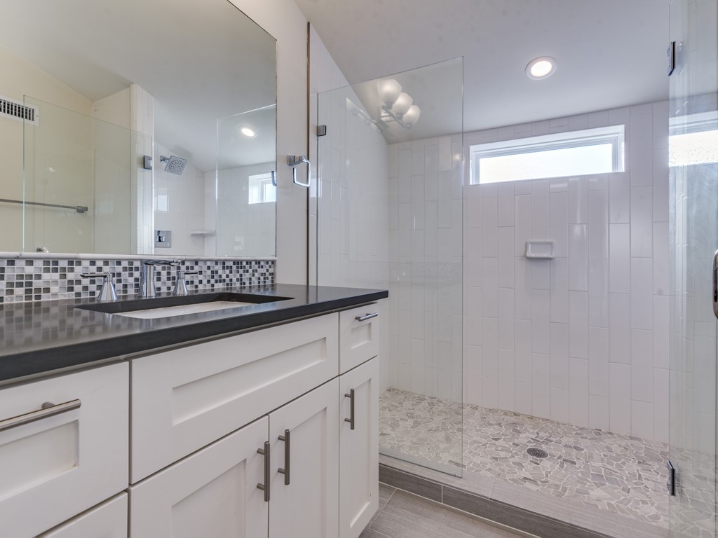 6412 Carson Ridge, Unit B Austin, TX 78741 - Photo 19 of 29 a bathroom with a sink and a mirror