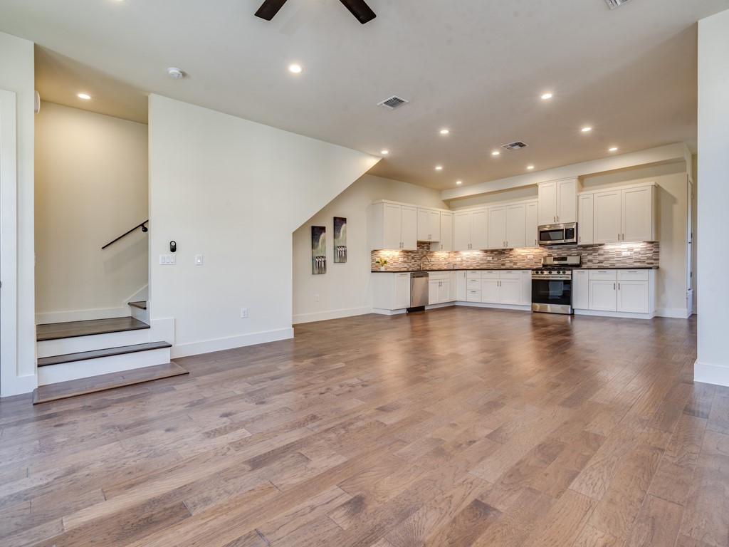 6412 Carson Ridge, Unit B Austin, TX 78741 - Photo 2 of 29 a view of kitchen with kitchen island microwave and stove top oven