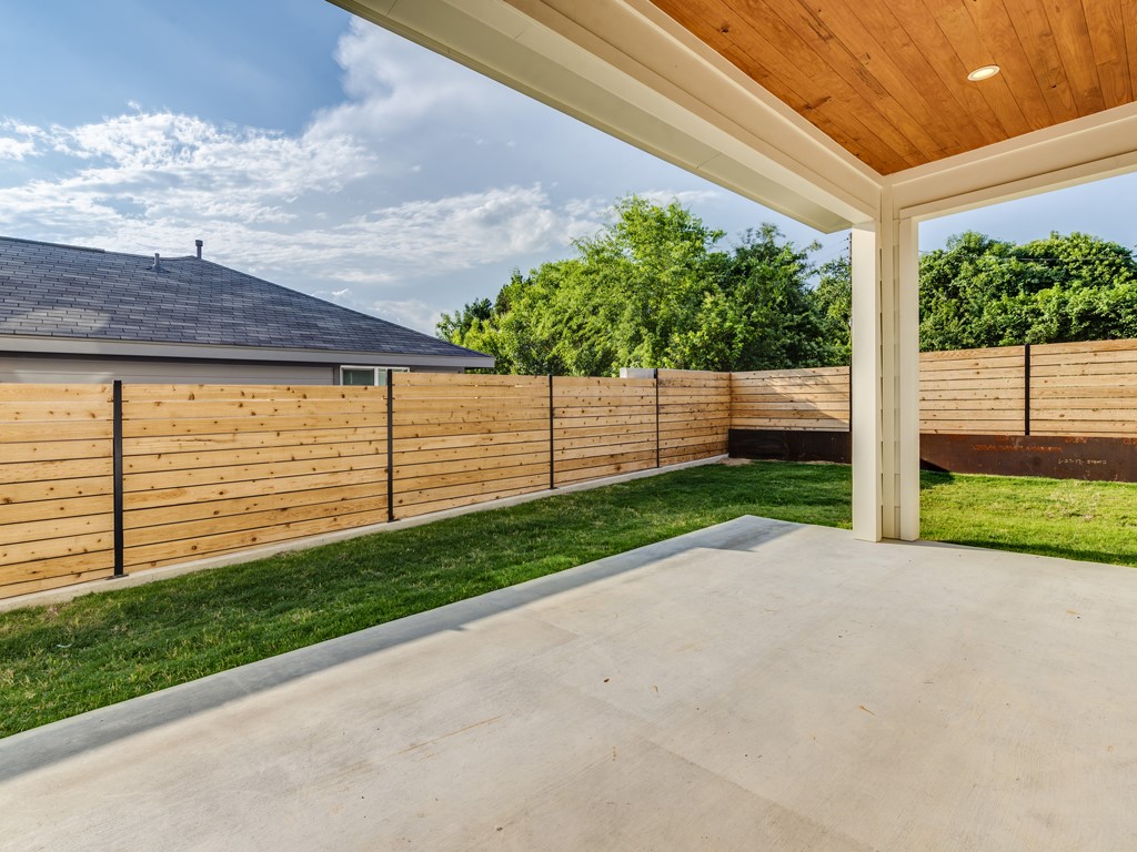 6412 Carson Ridge, Unit B Austin, TX 78741 - Photo 25 of 29 a view of a backyard with brick wall and a small yard