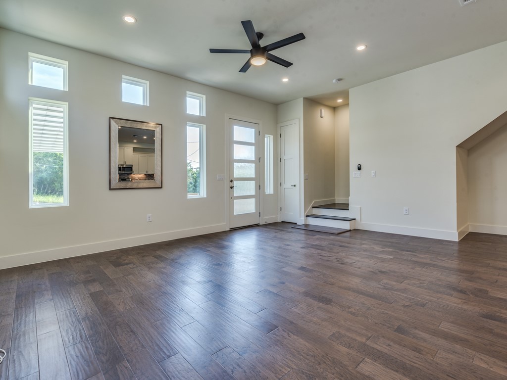 6412 Carson Ridge, Unit B Austin, TX 78741 - Photo 3 of 29 a view of an empty room with window and wooden floor