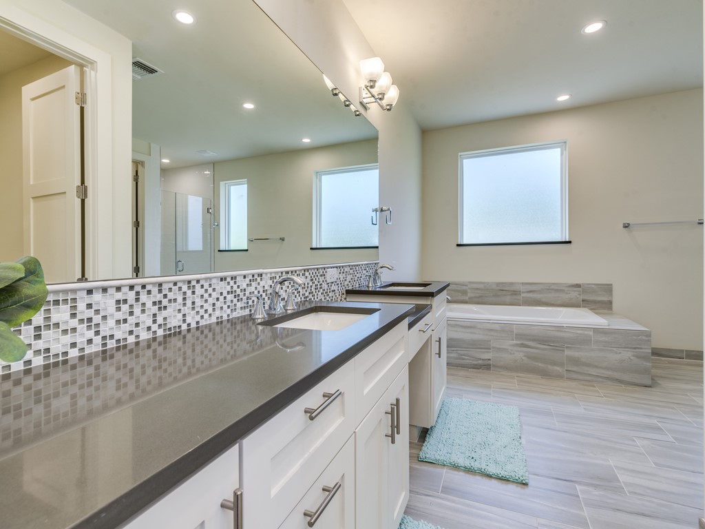 6412 Carson Ridge, Unit B Austin, TX 78741 - Photo 10 of 29 a bathroom with a sink and a mirror
