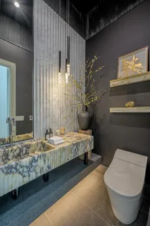 a kitchen with stainless steel appliances kitchen island granite countertop a refrigerator and a stove top oven