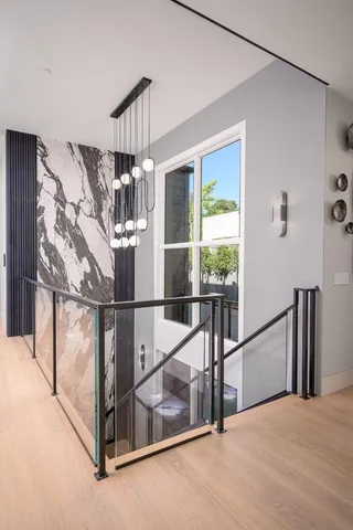 a living room with stainless steel appliances kitchen island granite countertop furniture and a wooden floor
