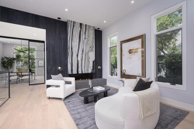 a living room with furniture and large windows