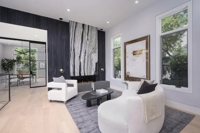 a living room with furniture and large windows