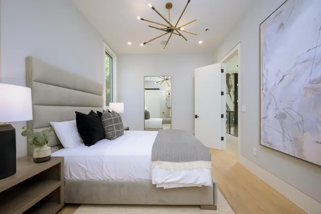 a large white kitchen with lots of counter space and stainless steel appliances