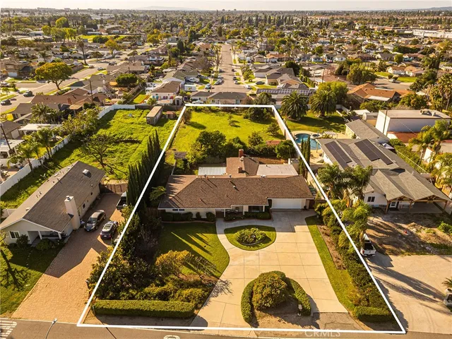 an aerial view of residential houses with yard