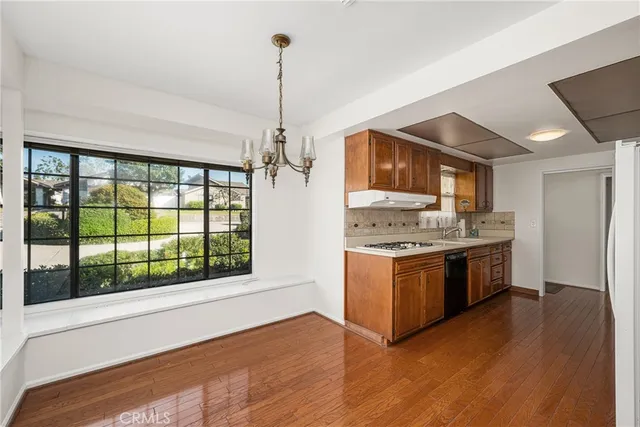 a kitchen with stainless steel appliances granite countertop a stove and a sink