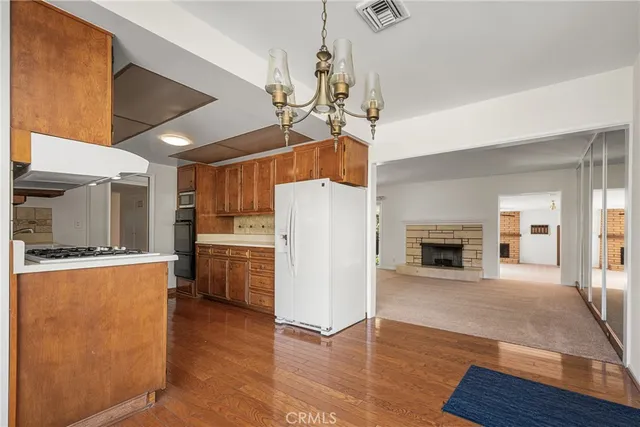 a view of a kitchen with furniture and wooden floor