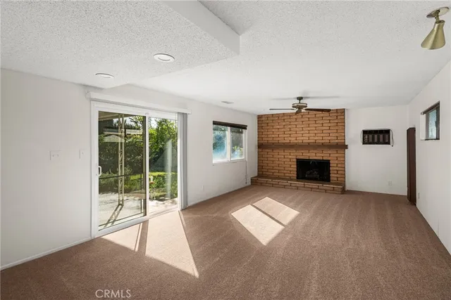 a view of empty room with a fireplace