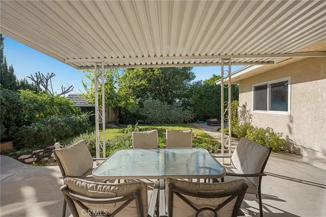 a patio with a table and chairs