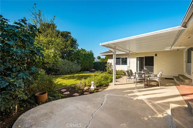 a view of a patio with table and chairs and potted plants