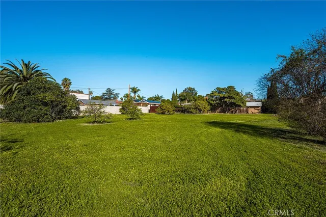 an aerial view of residential houses with yard