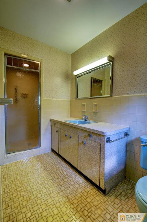 11 Stafford Road Colonia, NJ 07067 - Photo 17 of 25 a bathroom with a sink mirror and toilet