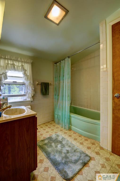 11 Stafford Road Colonia, NJ 07067 - Photo 20 of 25 a bathroom with a sink a toilet and shower