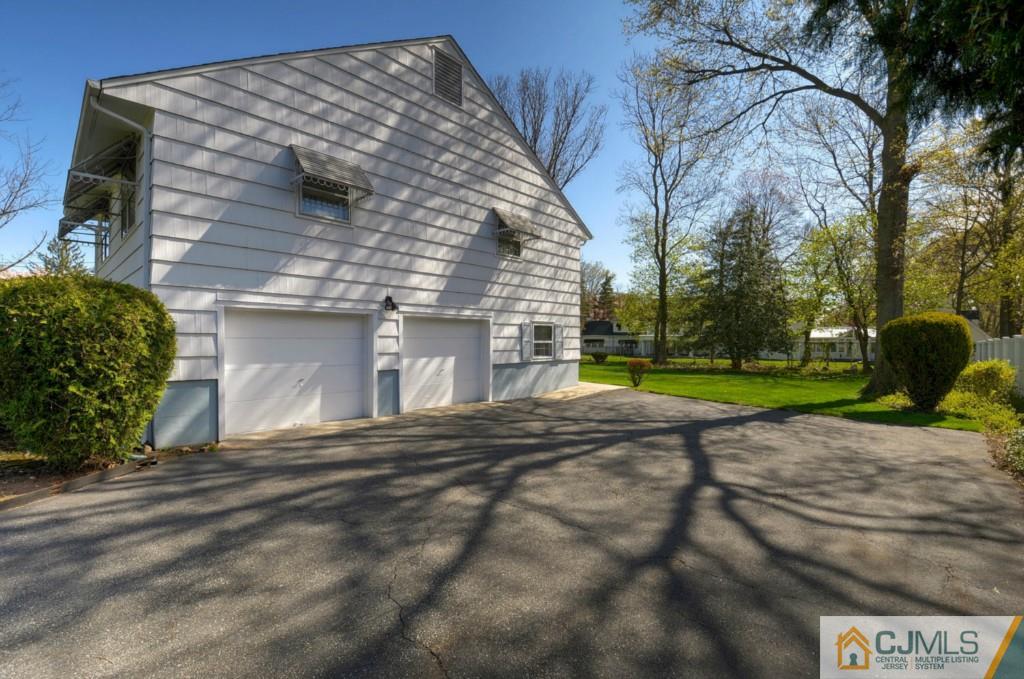 11 Stafford Road Colonia, NJ 07067 - Photo 21 of 25 a front view of a house with a yard and garage