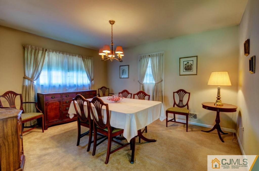 11 Stafford Road Colonia, NJ 07067 - Photo 7 of 25 a view of a dining room with furniture and chandelier