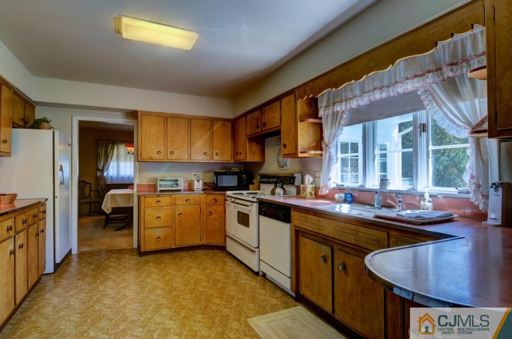 11 Stafford Road Colonia, NJ 07067 - Photo 9 of 25 a kitchen with stainless steel appliances granite countertop a sink a stove and a refrigerator