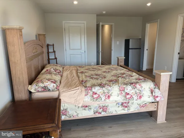 a bedroom with a bed and a dresser