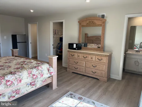 a bedroom with a bed and a dresser in it