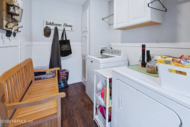 a spacious bedroom with a bed and a chandelier