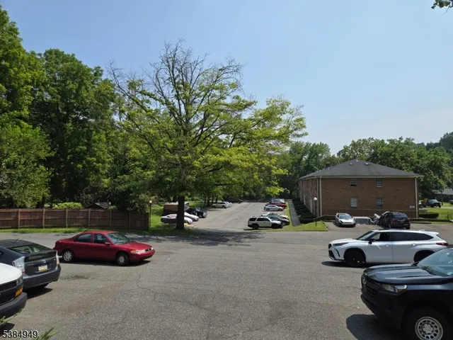 a view of a park with trees in the background