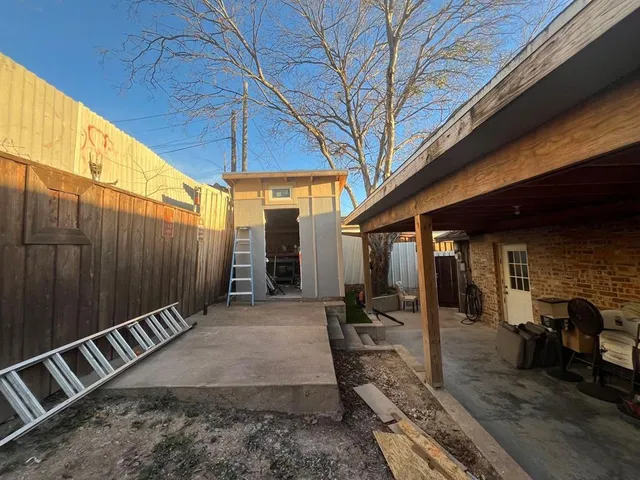 a view of a backyard with sitting area
