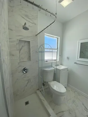 a bathroom with a toilet sink and shower