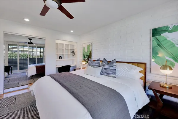 a large bedroom with a bed and a large window