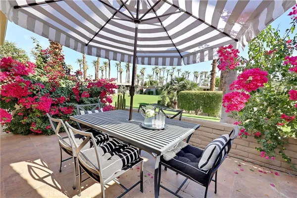 a view of a chairs and table in the patio