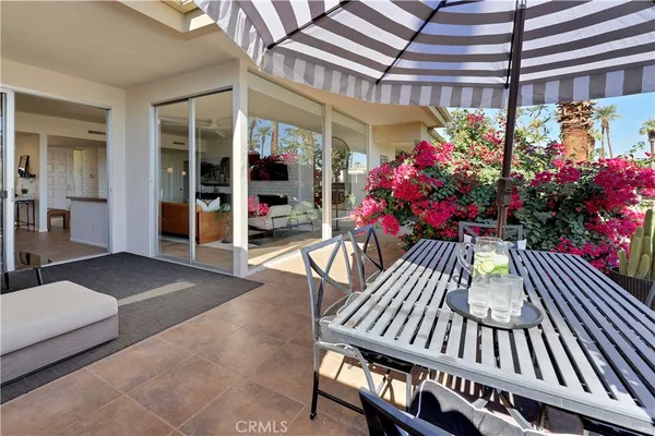 a view of a patio with a table and chairs