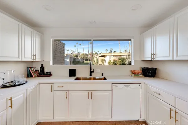 a kitchen with a sink cabinets and window