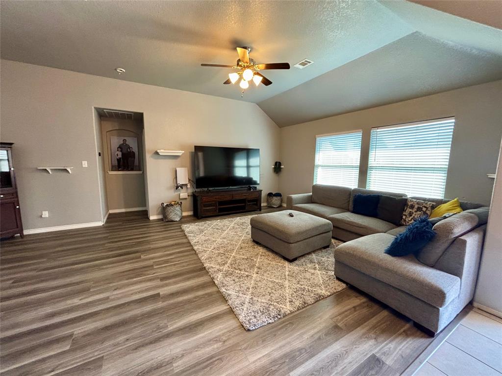 900 Grouse Road Glenn Heights, TX 75154 - Photo 2 of 13 a living room with furniture and a flat screen tv