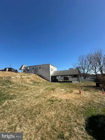 a backyard of a house with large trees