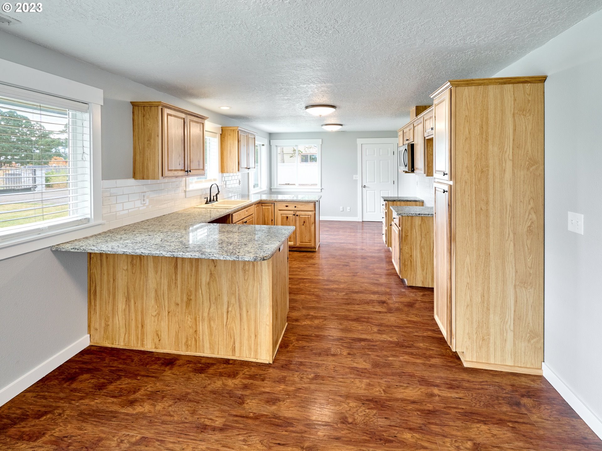 1185 Cordon Road Northeast Salem, OR 97317 - Photo 4 of 15 a view of kitchen and hall with wooden floor