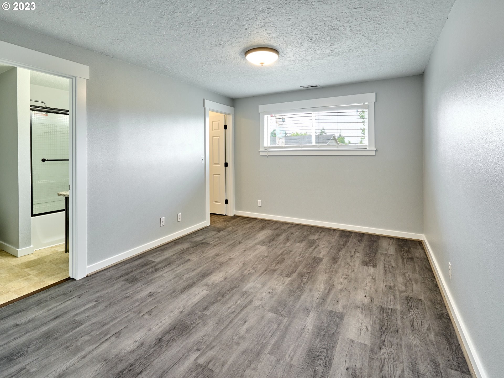 1185 Cordon Road Northeast Salem, OR 97317 - Photo 8 of 15 an empty room with wooden floor and windows