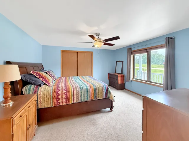 a spacious bedroom with a bed and a window