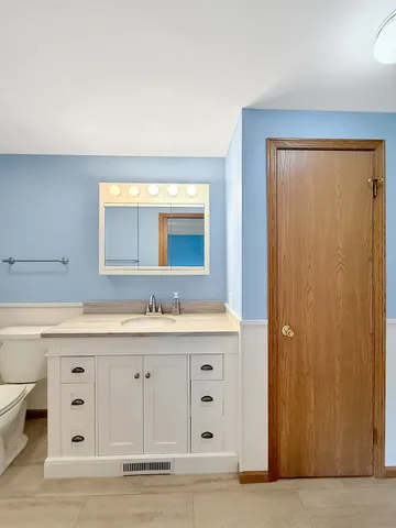 a bathroom with a granite countertop sink mirror and a