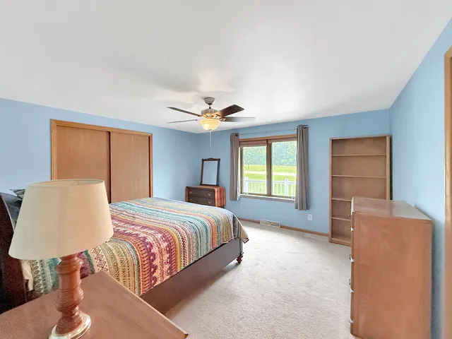 a bedroom with a large bed and a window