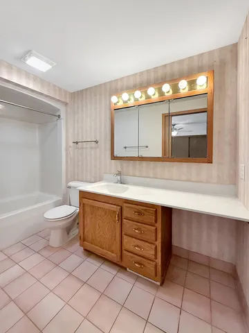 a bathroom with a sink a toilet and bathtub