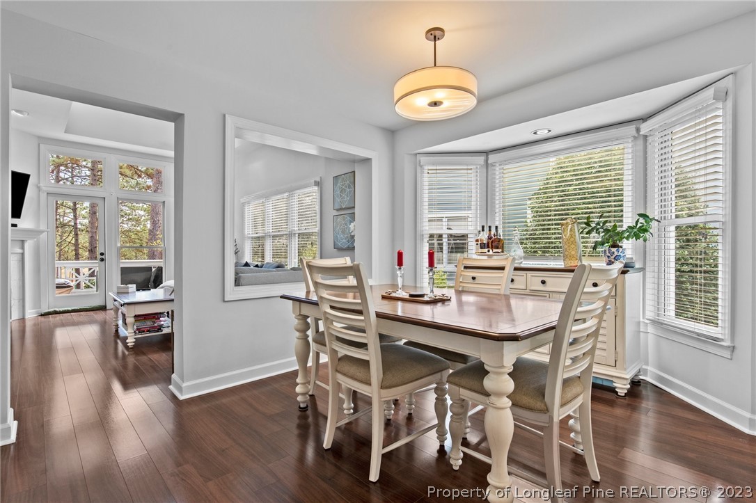 269 Knoll Road, Unit 409 Southern Pines, NC 28387 - Photo 11 of 40 a view of a dining room with furniture window and wooden floor