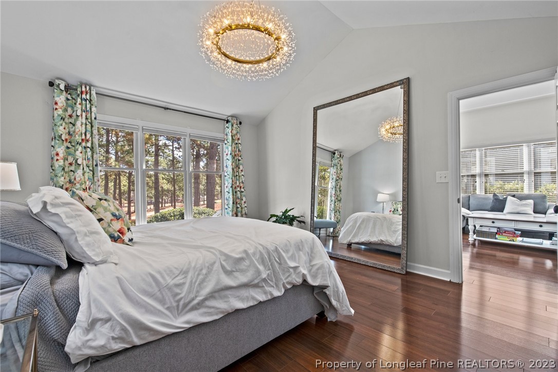 269 Knoll Road, Unit 409 Southern Pines, NC 28387 - Photo 17 of 40 a bedroom with a bed and wooden floor